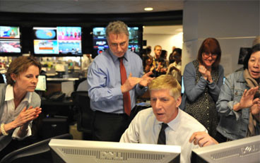 Washington Post Executive Editor Martin Baron, standing center, and Editor Ed Thiede, sitting, read the announcement of Pulitzer Prize winners on Monday.  The Washington Post's journalists won awards in Public Service and Explanatory Reporting, and were finalists in feature photography and breaking news coverage.